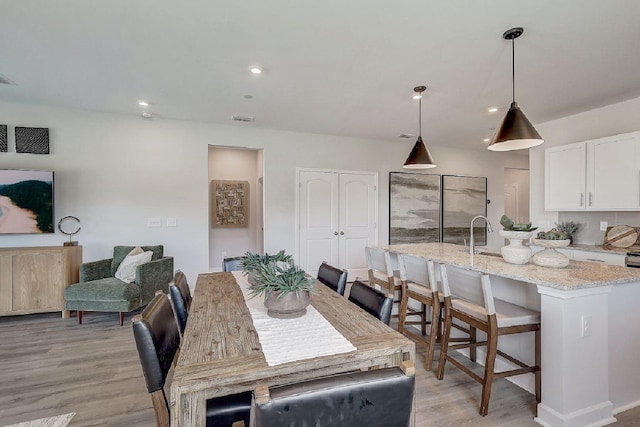dining area featuring recessed lighting, visible vents, and light wood-type flooring