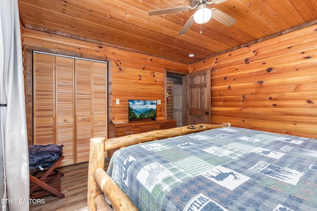 531 Gatlin Dr, Gatlinburg, TN 37738 - bedroom with wood finished floors, wooden walls, wooden ceiling, and a closet