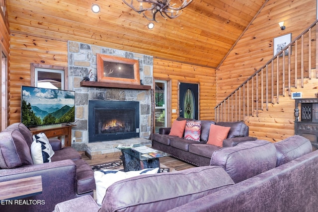 531 Gatlin Dr, Gatlinburg, TN 37738 - living area featuring stairway, wood ceiling, vaulted ceiling, log walls, and a stone fireplace