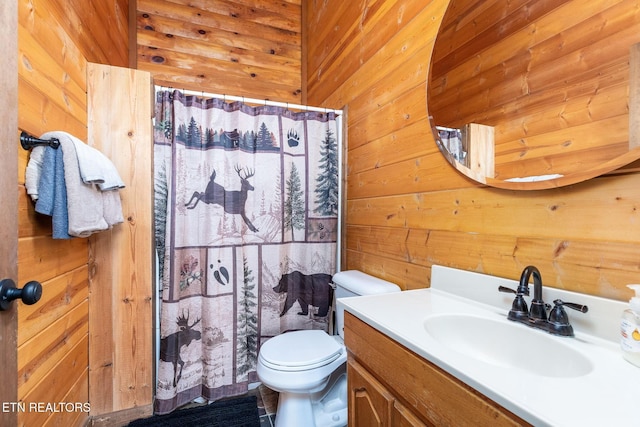 531 Gatlin Dr, Gatlinburg, TN 37738 - full bathroom with wooden walls, vanity, toilet, and a shower with curtain