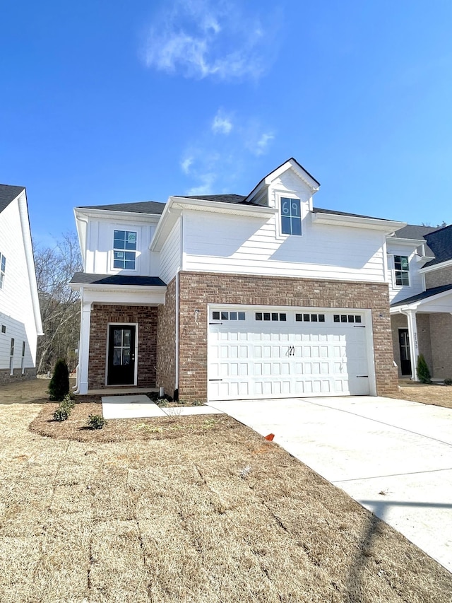 view of front of home featuring brick siding, driveway, and a garage