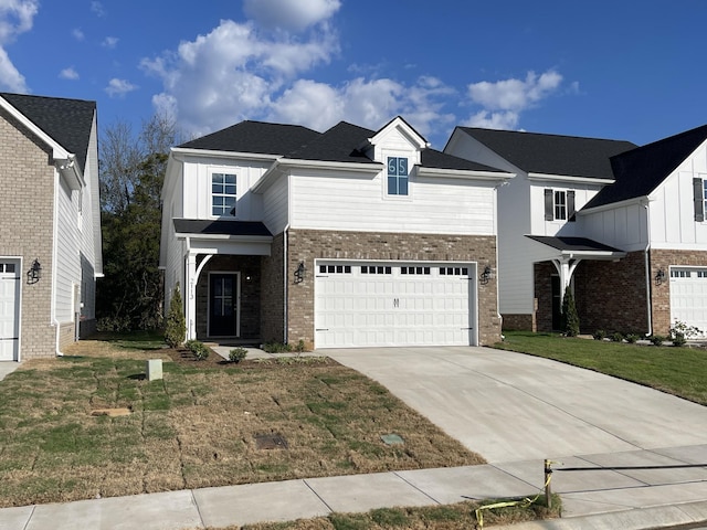 view of front of house with board and batten siding, a garage, brick siding, a front lawn, and concrete driveway