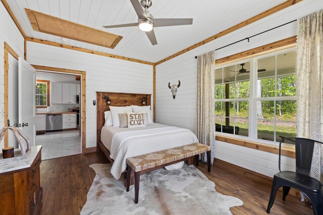 bedroom featuring wood-type flooring and wood walls