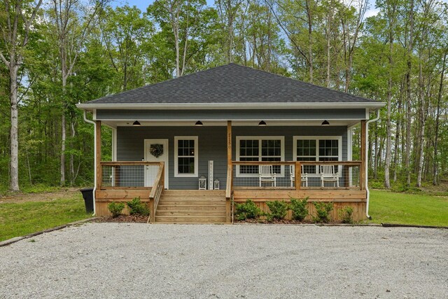 bungalow-style home with roof with shingles and covered porch