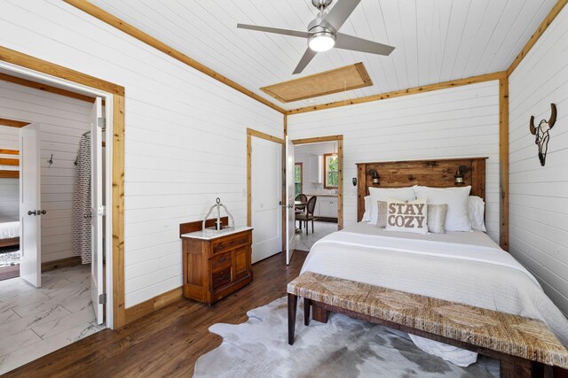 bedroom with wooden walls, wood ceiling, a ceiling fan, and dark wood-type flooring