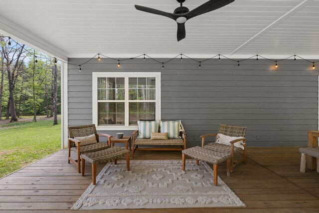 wooden terrace with an outdoor hangout area, ceiling fan, and a yard