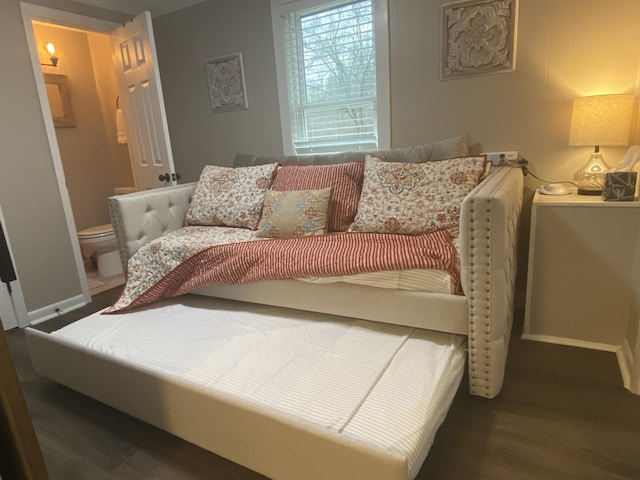 bedroom featuring baseboards and wood finished floors