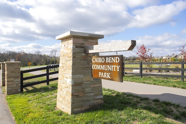 community / neighborhood sign with fence