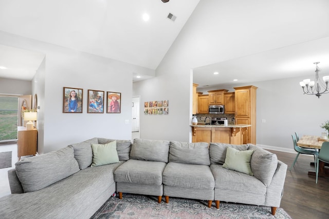 living room with visible vents, dark wood-type flooring, recessed lighting, a notable chandelier, and vaulted ceiling