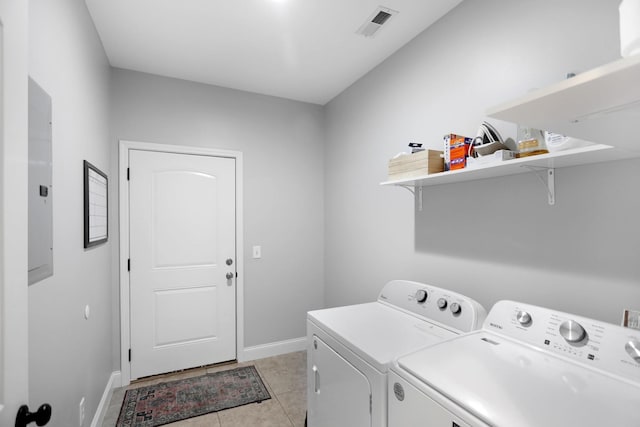 laundry room with laundry area, visible vents, washing machine and dryer, baseboards, and light tile patterned floors