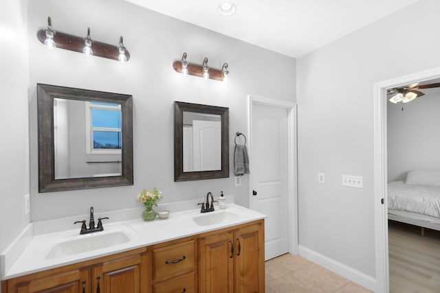 bathroom featuring double vanity, ensuite bathroom, a sink, and tile patterned flooring