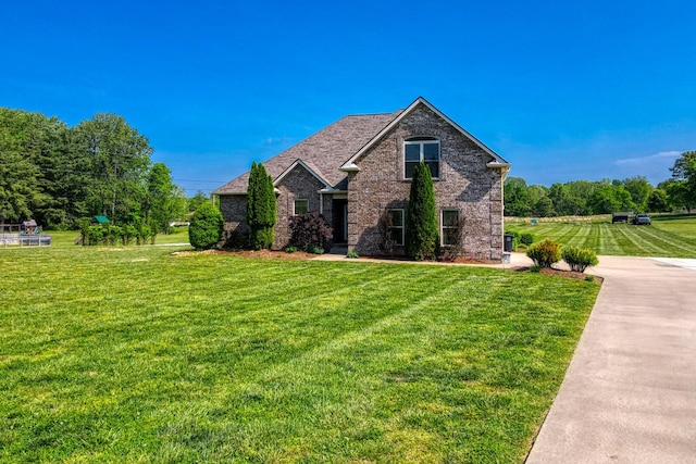view of side of home featuring a lawn and brick siding