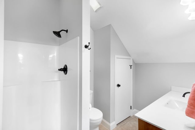 bathroom featuring tile patterned flooring, a shower, vanity, toilet, and lofted ceiling