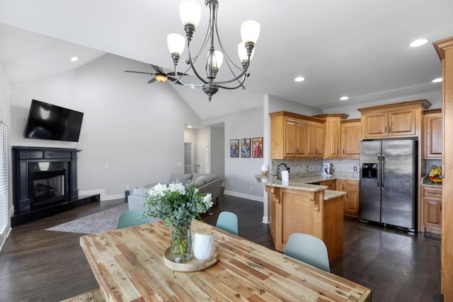 dining area featuring a fireplace with raised hearth, baseboards, recessed lighting, and dark wood finished floors