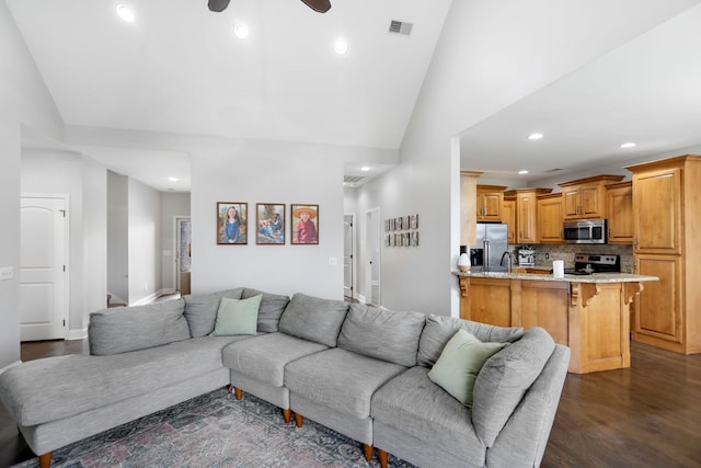 living area with visible vents, lofted ceiling, recessed lighting, a ceiling fan, and dark wood finished floors