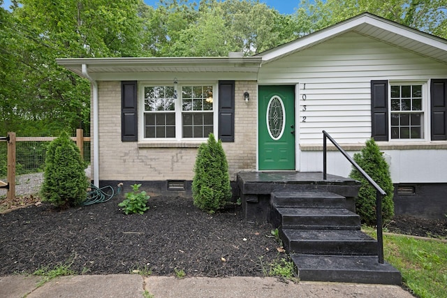 1032 Gordon Cir, Burns, TN 37029 - view of front facade featuring crawl space, brick siding, and fence