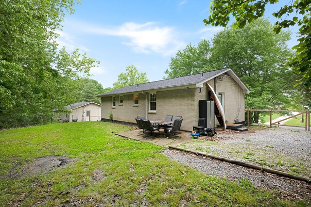 1032 Gordon Cir, Burns, TN 37029 - back of house featuring brick siding and a patio
