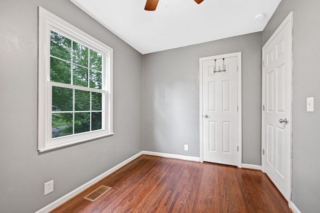 1032 Gordon Cir, Burns, TN 37029 - unfurnished bedroom featuring dark wood-type flooring, baseboards, and ceiling fan