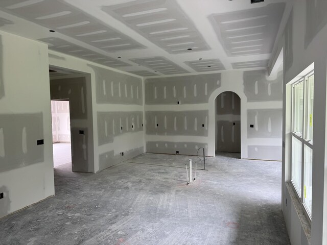 empty room featuring arched walkways