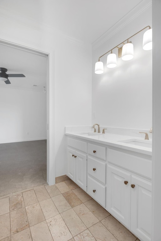 full bathroom featuring crown molding, a sink, ceiling fan, and double vanity