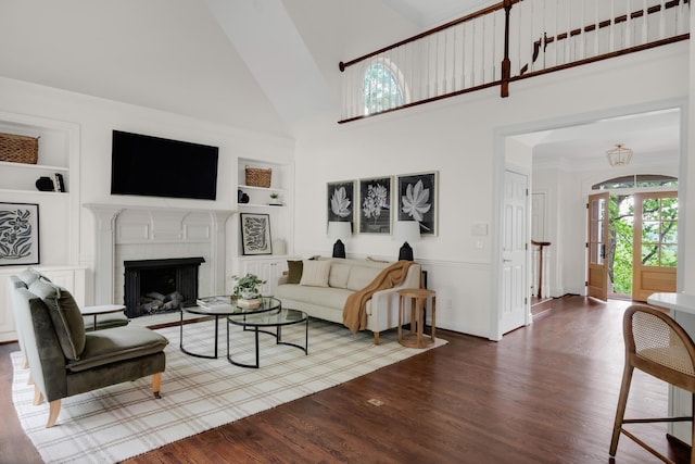 living room featuring high vaulted ceiling, wood finished floors, and built in shelves