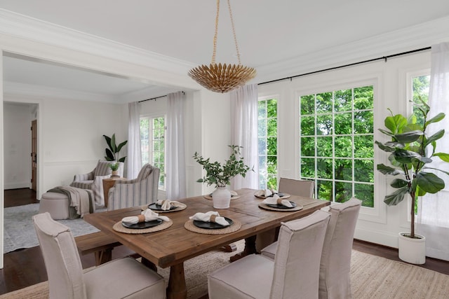dining area with crown molding and wood finished floors