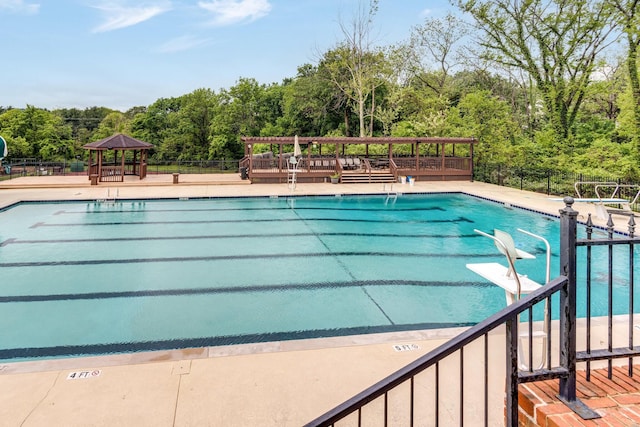 pool featuring a gazebo and fence