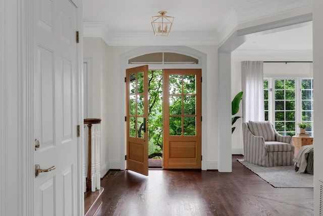 entryway featuring a healthy amount of sunlight, baseboards, and wood finished floors