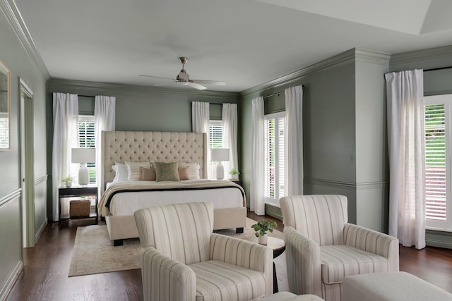 bedroom with baseboards, ornamental molding, dark wood-style flooring, and a ceiling fan