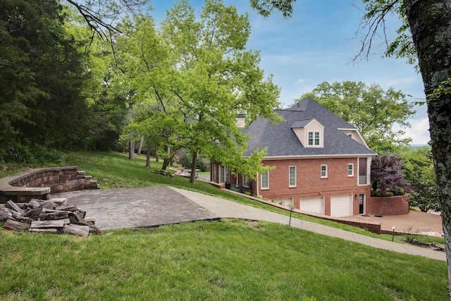 view of yard featuring a garage and a patio