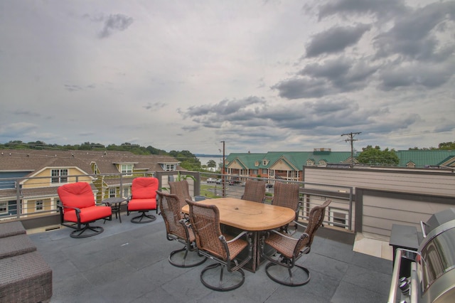 view of patio featuring outdoor dining space and a balcony