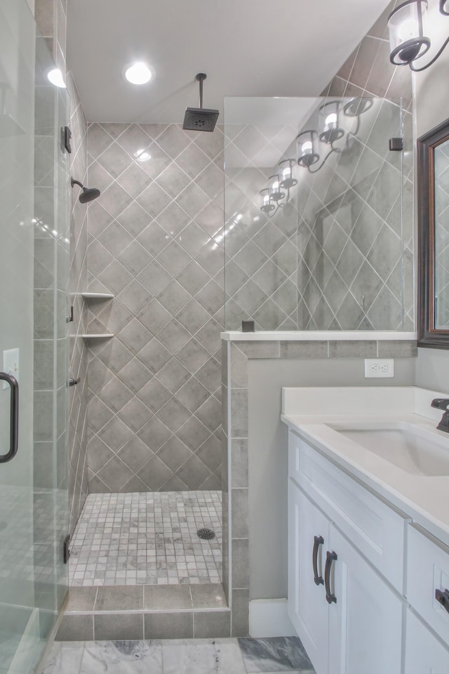 full bath with a shower stall, marble finish floor, and vanity