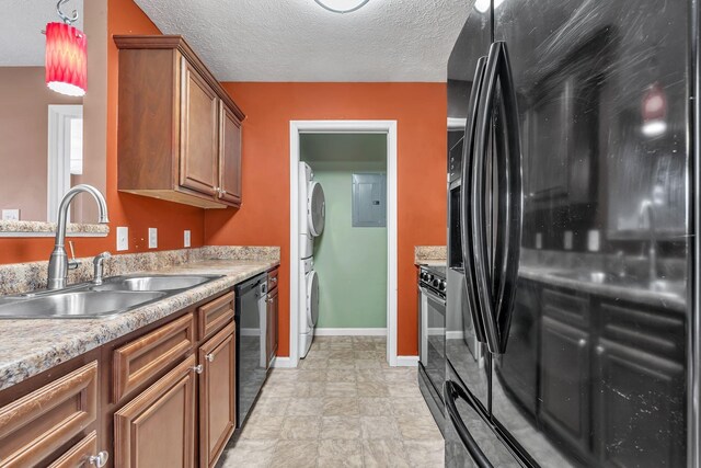 19 Winding Hills Ln, Gordonsville, TN 38563 - kitchen featuring black appliances, stacked washing machine and dryer, a sink, brown cabinets, and electric panel