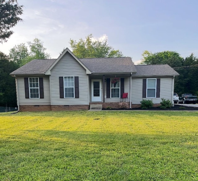 ranch-style home featuring a shingled roof, a front yard, a porch, and crawl space