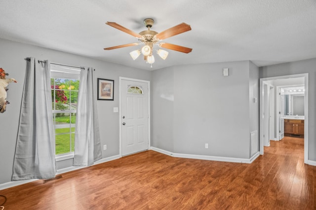3513 Hunters Rdg, Woodlawn, TN 37191 - entrance foyer featuring wood finished floors, a ceiling fan, baseboards, and a textured ceiling