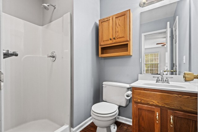 3513 Hunters Rdg, Woodlawn, TN 37191 - full bathroom with a stall shower, toilet, wood finished floors, vanity, and baseboards