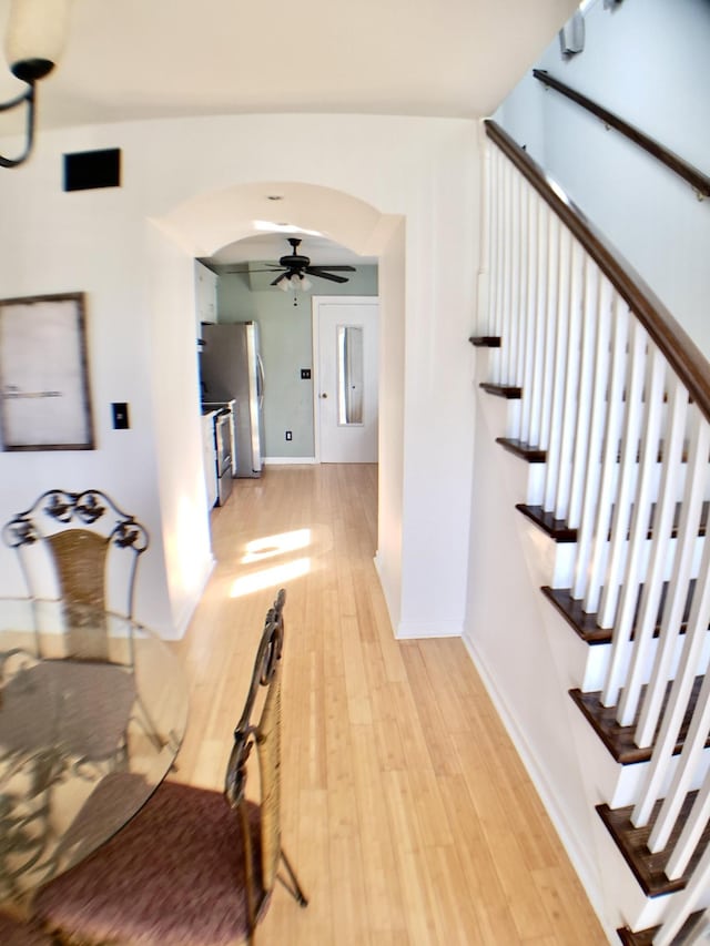 339 Perrolee St, Gallatin, TN 37066 - hall with arched walkways, baseboards, light wood-style flooring, and stairway