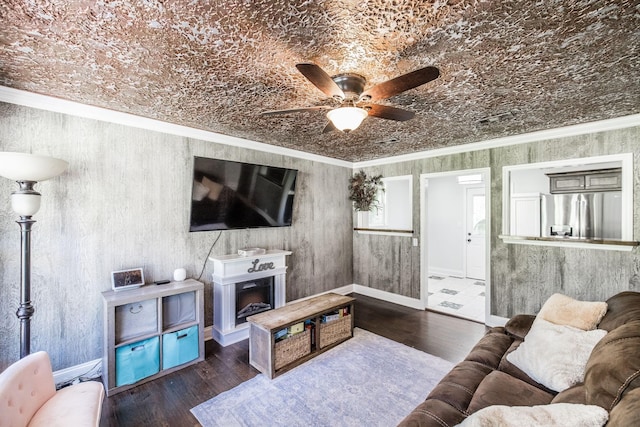 907 N Graycroft Ave, Madison, TN 37115 - living area with a ceiling fan, wood finished floors, crown molding, a fireplace with raised hearth, and baseboards