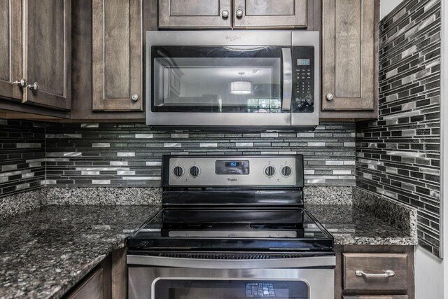 907 N Graycroft Ave, Madison, TN 37115 - kitchen featuring appliances with stainless steel finishes, backsplash, dark brown cabinetry, and dark stone countertops