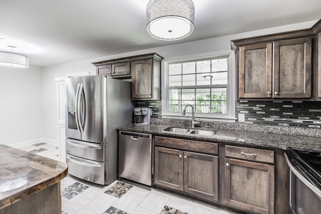 907 N Graycroft Ave, Madison, TN 37115 - kitchen featuring a sink, stainless steel appliances, dark brown cabinets, and tasteful backsplash