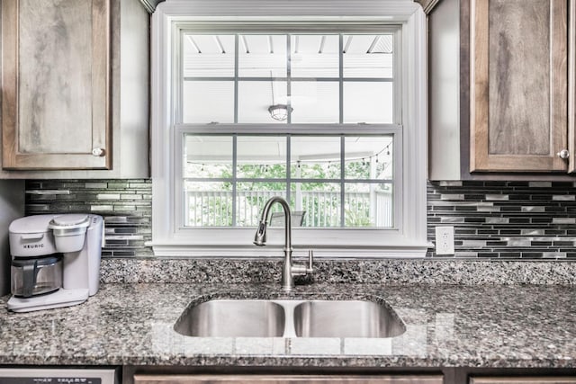 907 N Graycroft Ave, Madison, TN 37115 - kitchen with a sink, decorative backsplash, plenty of natural light, and dark stone counters