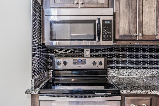 907 N Graycroft Ave, Madison, TN 37115 - kitchen with appliances with stainless steel finishes, decorative backsplash, and dark brown cabinets