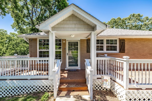 907 N Graycroft Ave, Madison, TN 37115 - entrance to property featuring brick siding, a shingled roof, and a wooden deck