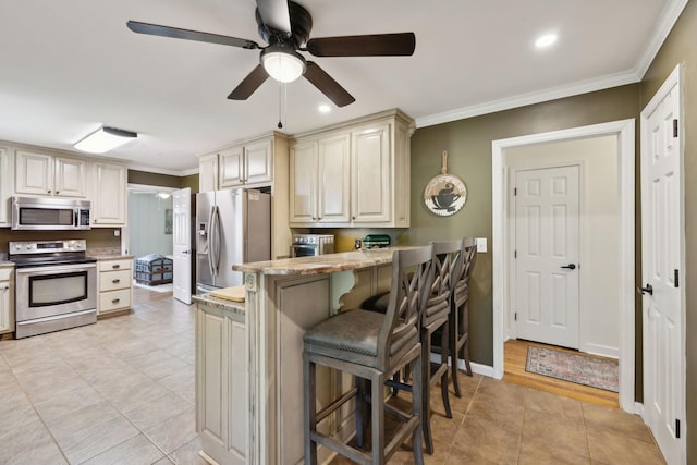 206 Evergreen Dr, Columbia, TN 38401 - kitchen with ornamental molding, a peninsula, a breakfast bar area, a ceiling fan, and stainless steel appliances