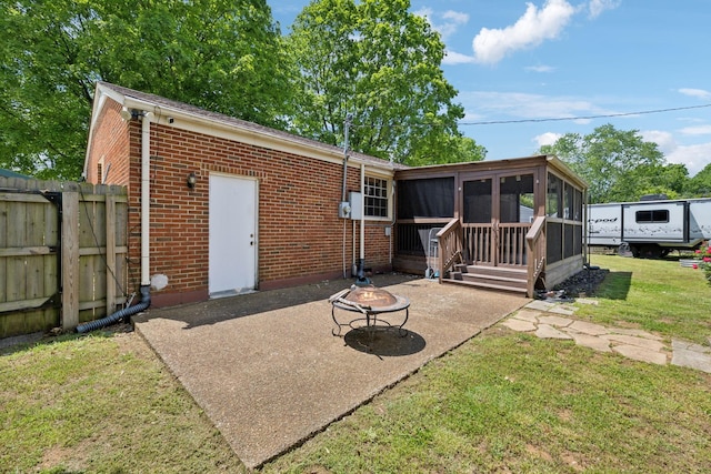 206 Evergreen Dr, Columbia, TN 38401 - rear view of property featuring an outdoor fire pit, brick siding, a sunroom, a patio, and a yard