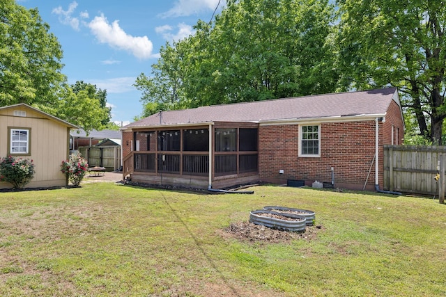 206 Evergreen Dr, Columbia, TN 38401 - rear view of property featuring a fenced backyard, a yard, a sunroom, and a fire pit