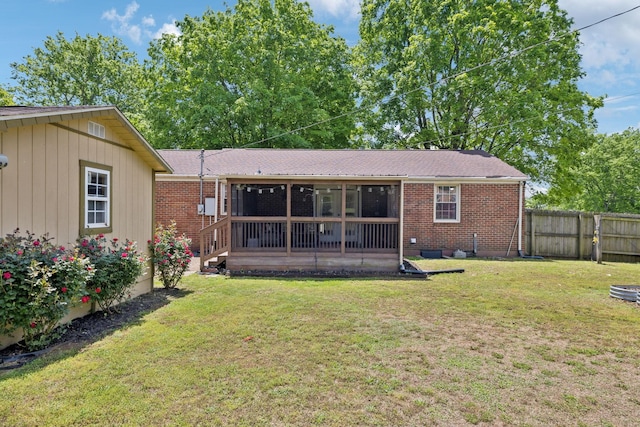 206 Evergreen Dr, Columbia, TN 38401 - rear view of house with brick siding, a lawn, fence, and a sunroom