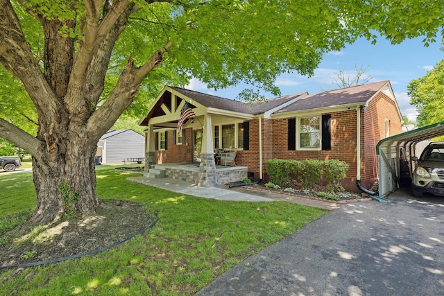 206 Evergreen Dr, Columbia, TN 38401 - view of front facade with a shingled roof, a front lawn, brick siding, a detached carport, and covered porch