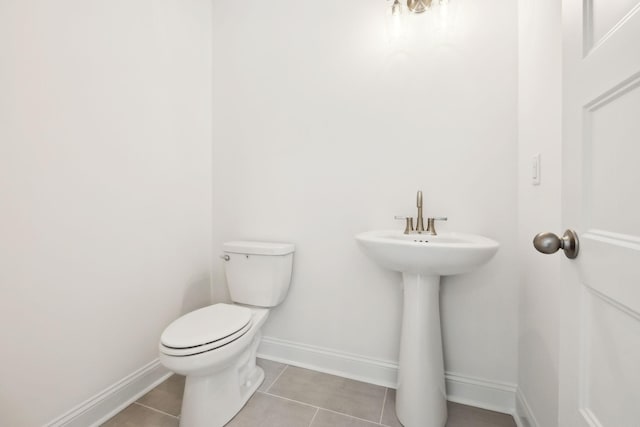 1065 Gholson Rd, Clarksville, TN 37043 - half bathroom featuring baseboards, a sink, tile patterned floors, and toilet