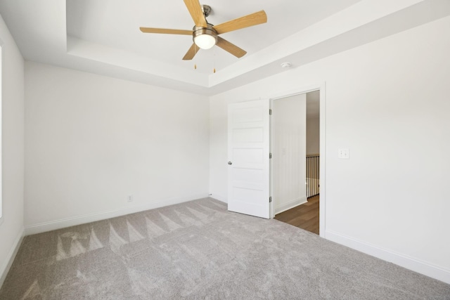 1065 Gholson Rd, Clarksville, TN 37043 - carpeted empty room featuring a raised ceiling, baseboards, and a ceiling fan